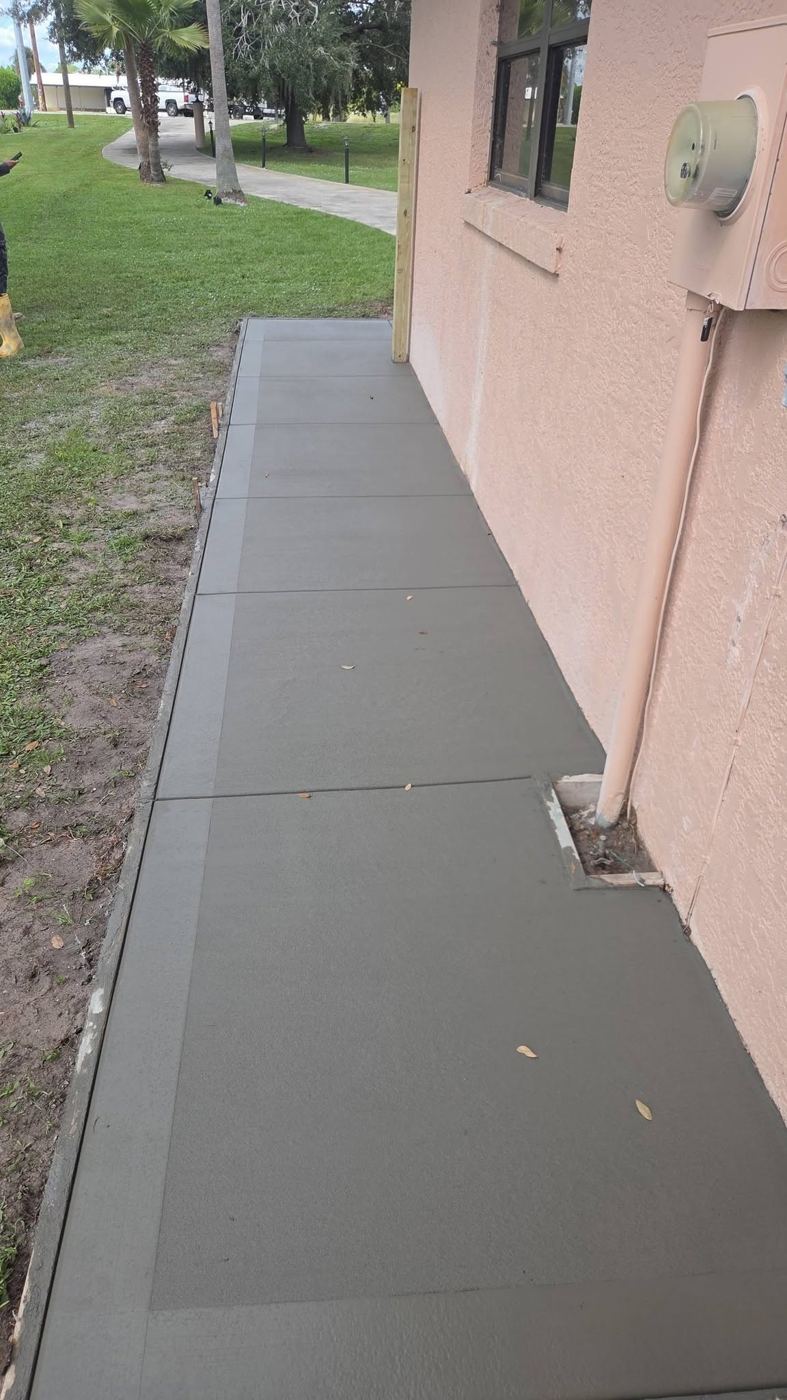 Concrete walkway beside a stucco home