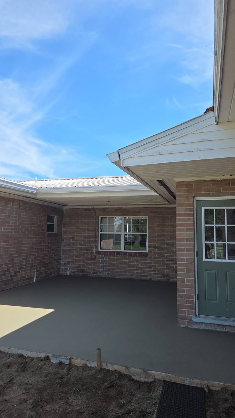 Patio poured beside a brick home